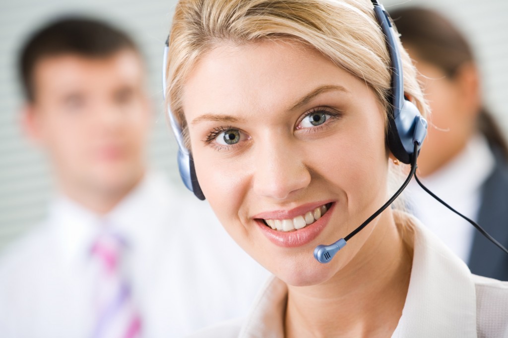 Face of young charming confidant woman with headset